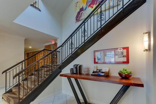 a staircase with a wooden table in a living room at The Mantissa Hotel in Hartsville