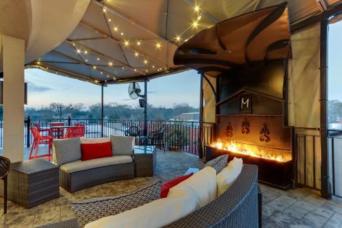 an outdoor patio with a fireplace and couches at The Mantissa Hotel in Hartsville