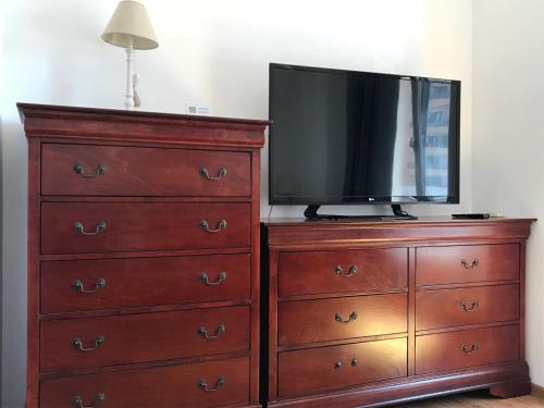 a television sitting on top of a dresser at Orange Onix Apartaments in Bucharest