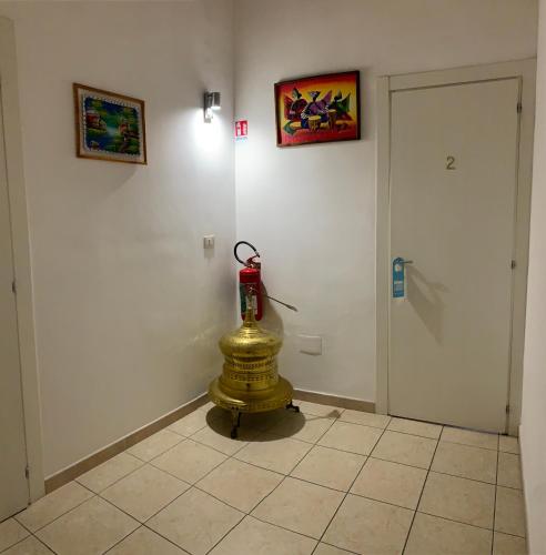 a room with a fire hydrant on a tiled floor at La Tela Bianca in Naples