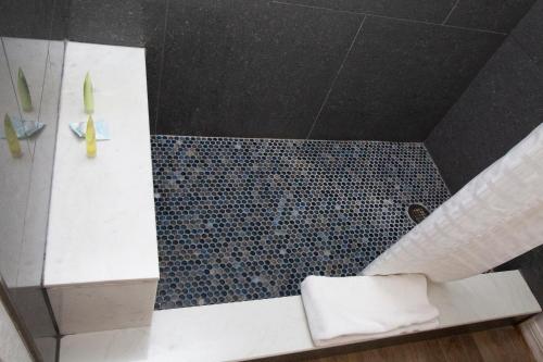 an overhead view of a bathroom with a shower at Daytona Dream Inn By AmeriVu in Daytona Beach
