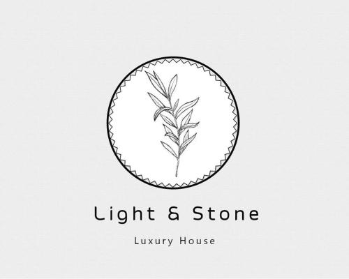 a black and white logo for a light and stone luxury house at The House. Light & Stone. in Lixouri
