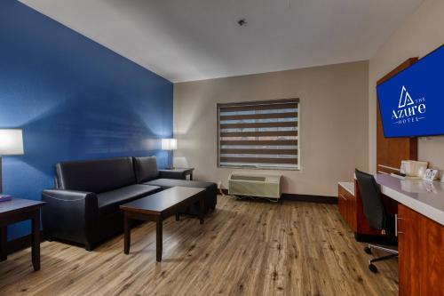 a living room with a couch and a table at The Azure Hotel in Mesa