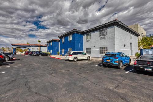 a parking lot with cars parked in front of a building at The Azure Hotel in Mesa