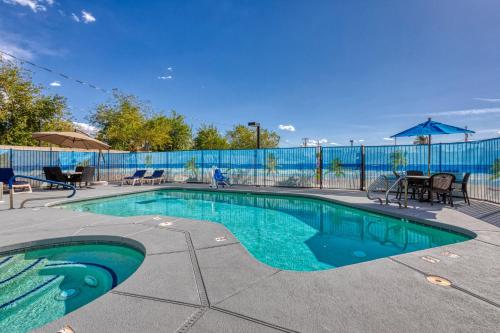 a swimming pool with blue water in a yard at The Azure Hotel in Mesa