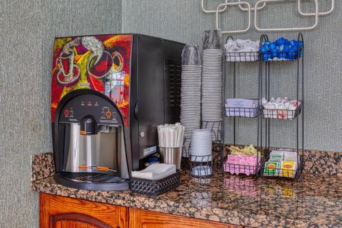 a counter with a coffee maker on top of it at The Azure Hotel in Mesa