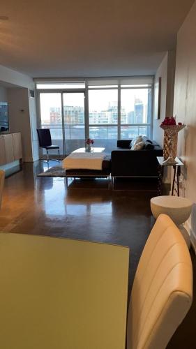 a living room with a couch and a table at Toronto Downtown Luxurious Stylish 3 Bedroom 3 Bath 2 Balconies near Rogers Centre lakeview condo in Toronto