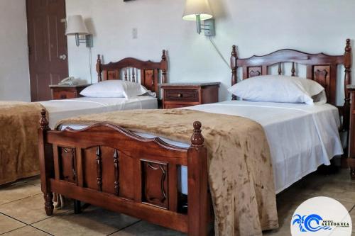 Ένα ή περισσότερα κρεβάτια σε δωμάτιο στο Hotel California Panama