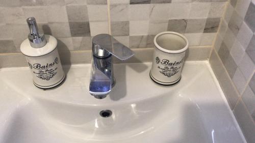 a sink with two bottles and a faucet on it at Center apartment Neno in Split