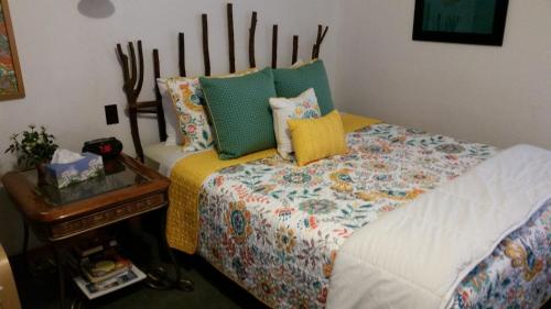 a bedroom with a bed and a nightstand next to it at Bay Port Lodging in Frankfort
