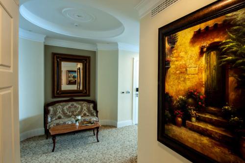 a living room with a painting on the wall and a couch at Royal Princess Hotel in Dubrovnik