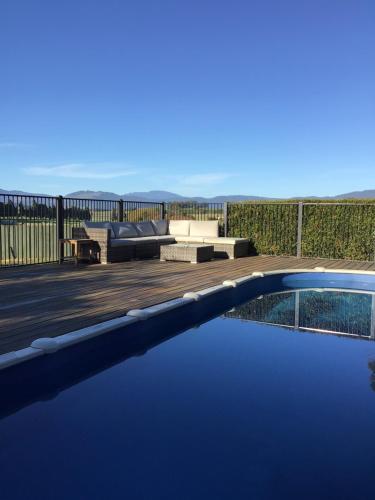 a swimming pool with a couch and a patio at Willowlodge in Scottsdale