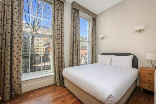 Säng eller sängar i ett rum på Tavistock Place Apartments