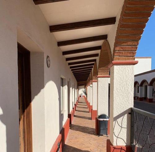 an empty hallway of a building with a clock on it at Hotel Andares de Kino by Rotamundos in Magdalena de Kino