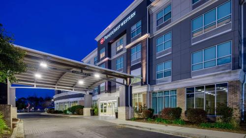 a rendering of the front of a hotel at night at Best Western Premier I-95 Savannah Airport/ Pooler West in Savannah