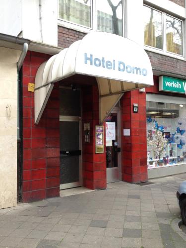 a hotel dome sign on the front of a building at Domo Hotel Mondial in Düsseldorf