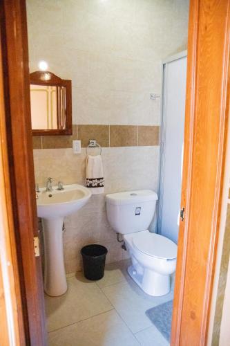 a bathroom with a toilet and a sink at Cuartel 1914 - Hotel Boutique in Zacatecas