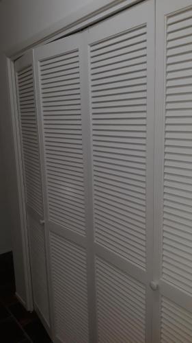 a white closet with white doors in a room at Silverado Golf Course View Property in Napa