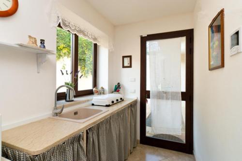 a kitchen with a sink and a window at Open Space San Cusumano in Erice