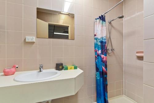 a bathroom with a sink and a shower at Cosmo on Bank in Adelaide