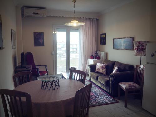 a living room with a table and a couch at Sunny apartment near the center in Thessaloniki
