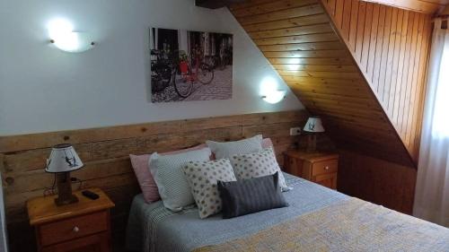 a bedroom with a bed with pillows on it at Ço d´Eric in Vielha