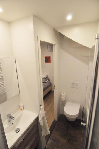 a bathroom with a toilet and a sink at Stylish house in the heart of Breda city center in Breda