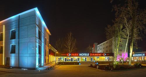 a building with blue lights on it at night at Park Hotel Diament Zabrze - Gliwice in Zabrze
