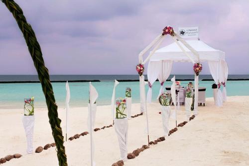 a wedding ceremony on the beach in the sand at Constance Halaveli in Hangnaameedhoo