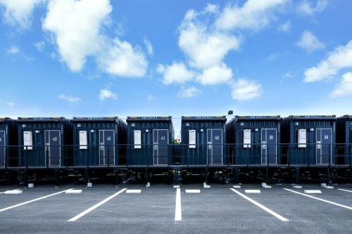 a row of portable toilets in a parking lot at HOTEL R9 The Yard Miyakojima in Miyako Island