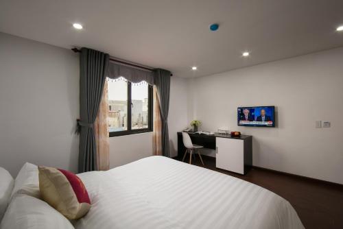 Giường trong phòng chung tại Hanoi Aria Central Hotel & Spa