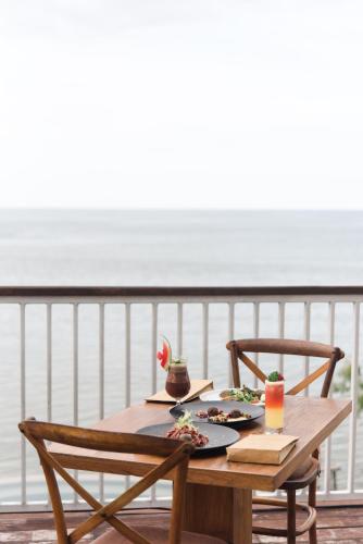 a wooden table with two plates of food on it at Plataran Menjangan Resort and Spa - CHSE Certified in Banyuwedang