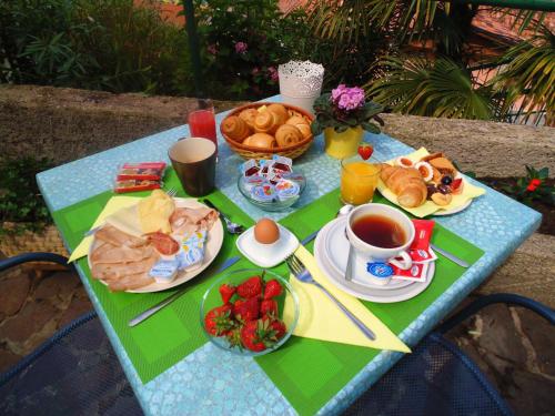 a table with breakfast foods and a cup of coffee at Villa Emma Malcesine in Malcesine