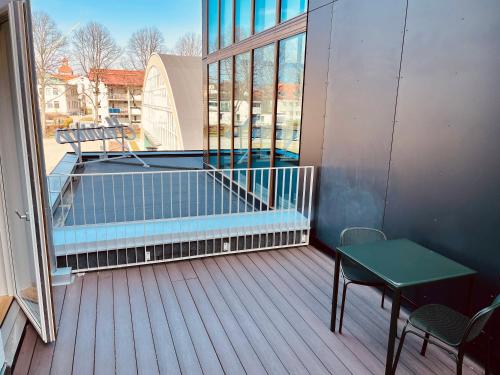 a balcony with a table and a swimming pool at Fritiden Hotell & Kongress in Ystad