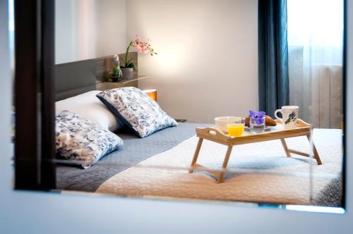 a bedroom with a bed with a table in front of a mirror at Apartment & Rooms Graciela in Rovinj