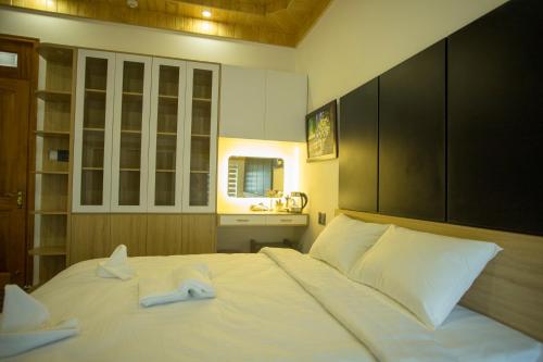 a bedroom with a bed with two towels on it at Win Villa Coffee in Da Lat