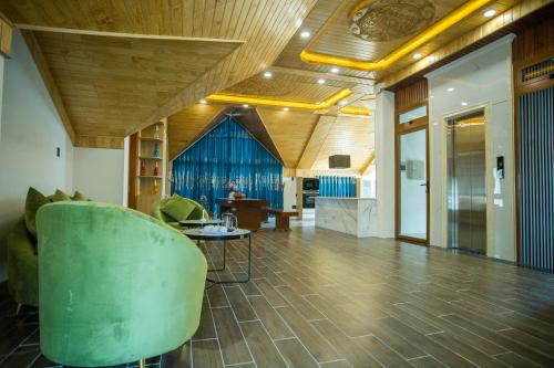 a living room with a green chair and a table at Win Villa Coffee in Da Lat