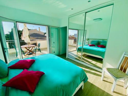 a bedroom with a blue bed with red pillows at Villa Isla Bonita in Sa Ràpita