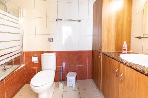 a bathroom with a toilet and a sink at Seafront Protaras Apartments in Protaras