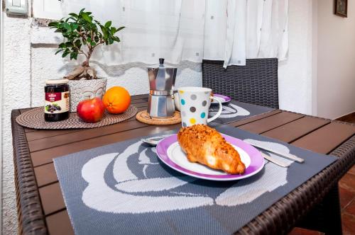 a table with a plate of food on a table at Apartment & Rooms Graciela in Rovinj