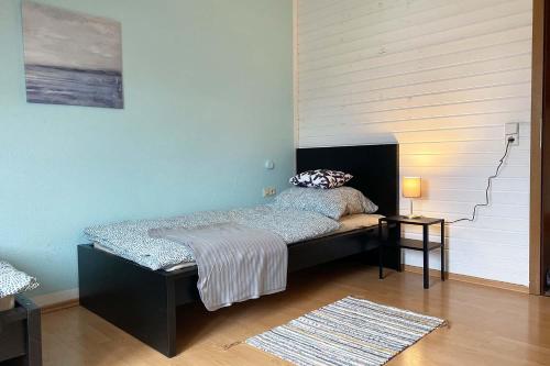 a bedroom with a bed and a stair case at Ferienwohnung in Laichingen-Feldstetten in Laichingen