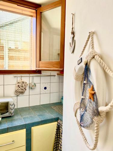 a kitchen with a towel hanging on a wall at Marettimo Appartamenti in Marettimo