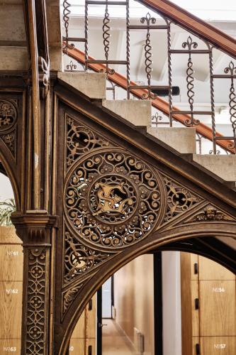 an entrance to a building with an ornate wooden stair railing at Hotel Arena in Amsterdam