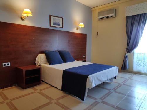 Giường trong phòng chung tại Hotel Perú by Bossh Hotels