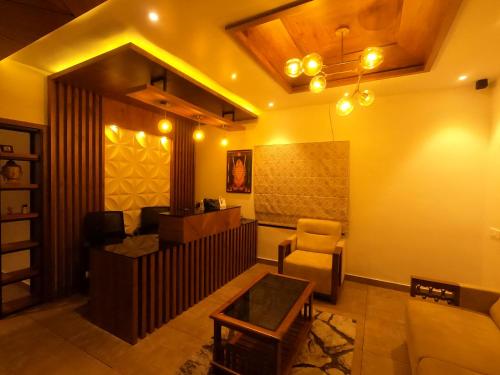 a living room with a couch and a chair at The Wild Trails Clarks Exotica , Munnar in Munnar