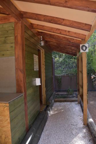 an outside view of a wooden building with a door at Salema Eco Camp - Sustainable Camping & Glamping in Salema