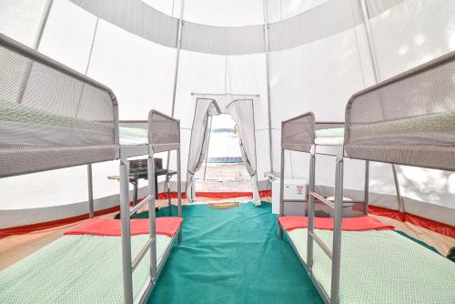a room with two bunk beds in a tent at Salema Eco Camp - Sustainable Camping & Glamping in Salema