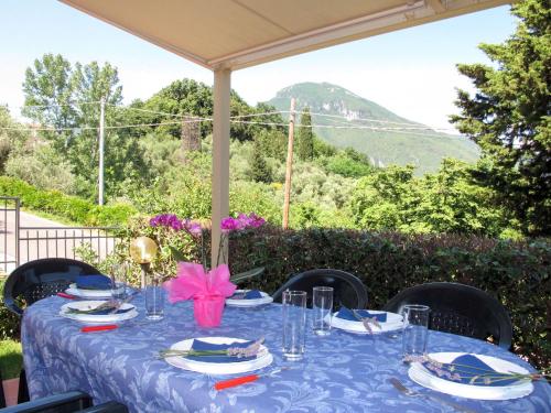 a table with a blue table cloth and a view of a mountain at Holiday Home Cristina-2 by Interhome in Santa Lucia