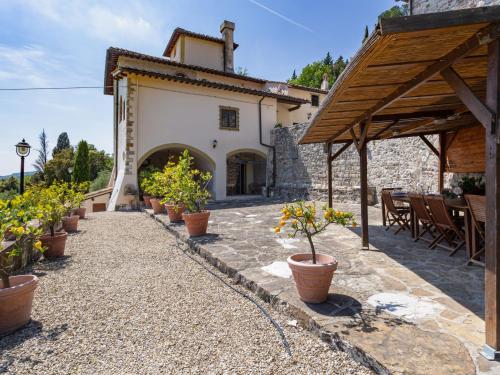 a patio with potted plants and a building at Villa Villa Monteloro by Interhome in Ellera