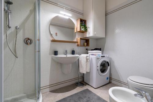 a bathroom with a washing machine and a sink at CA' MALIPIERO in Venice